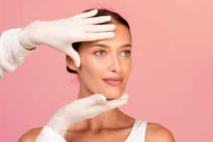Doctor examining woman's face for a facelift in Savanna, GA