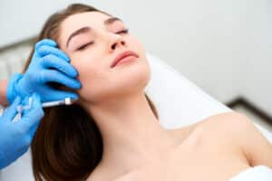 Woman relaxing while getting dermal filler injections in Savannah, GA
