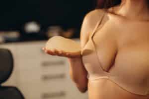 Woman holding breast implant in Savannah, GA